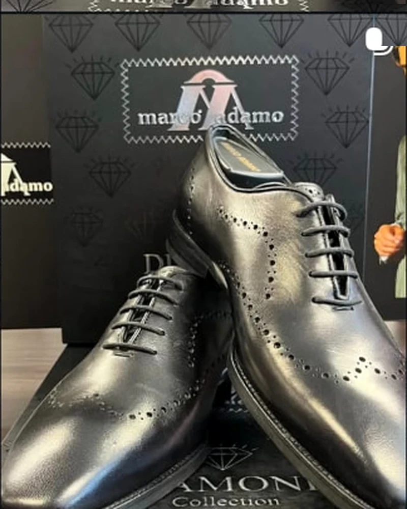 Pair of black leather perforated lace-up shoes