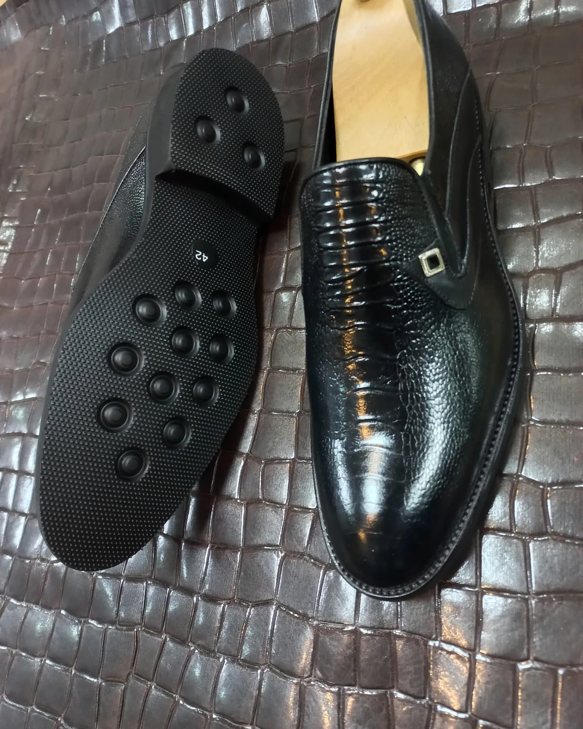 Black high-shine textured loafer with a studded sole